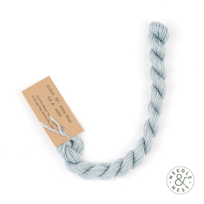 Silk & Ivory Slate Blue Thread on a White Background