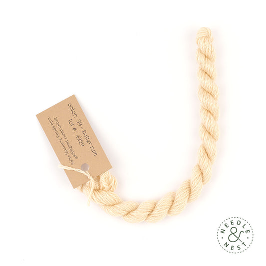 Silk & Ivory Butter Rum Thread on a White Background