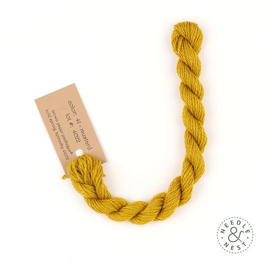 Silk & Ivory Mustard Thread on a White Background