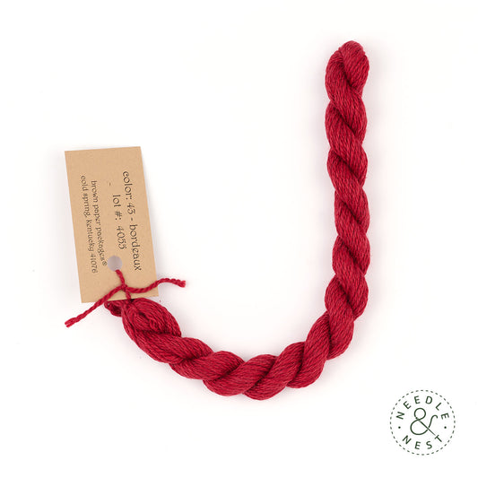 Silk & Ivory Bordeaux Thread on a White Background