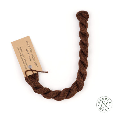 Silk & Ivory Coffee Bean Thread on a White Background