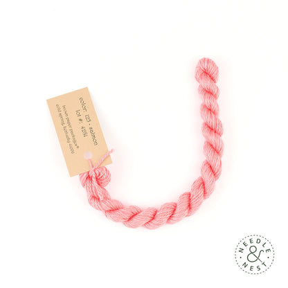 Silk & Ivory Salmon Thread on a White Background