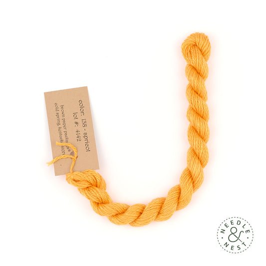 Silk & Ivory Apricot Thread on a White Background