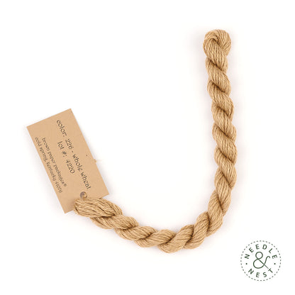 Silk & Ivory Whole Wheat Thread on a White Background